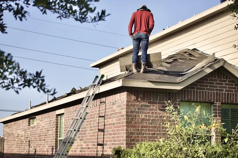 Professional roofer working on a residential roof in Mission Oaks